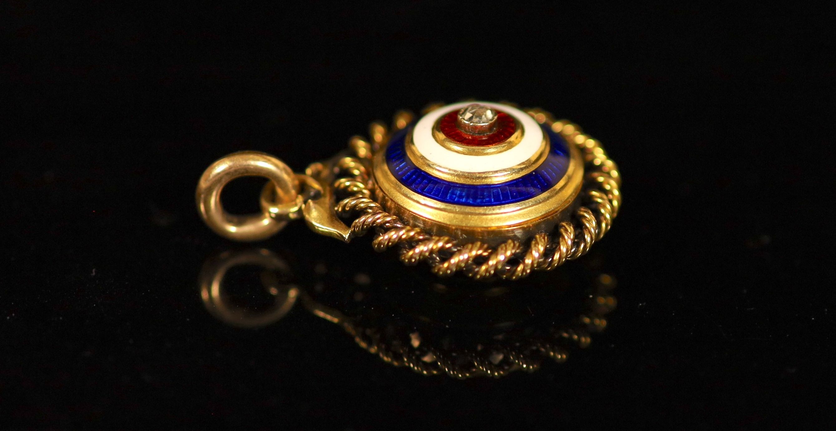 A Victorian gold, three colour enamel and rose cut diamond set circular target pendant